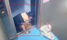 A woman pours trash and dirty water into the elevator.